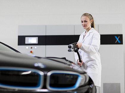 Employee holding a TrueData X-HVE charge discharge Unit in her Hand