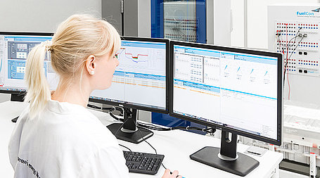 Employee siting on Screens and operating a Test System