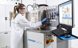 Employee adjusting something on a Test System for SOFC Single Cells and Components