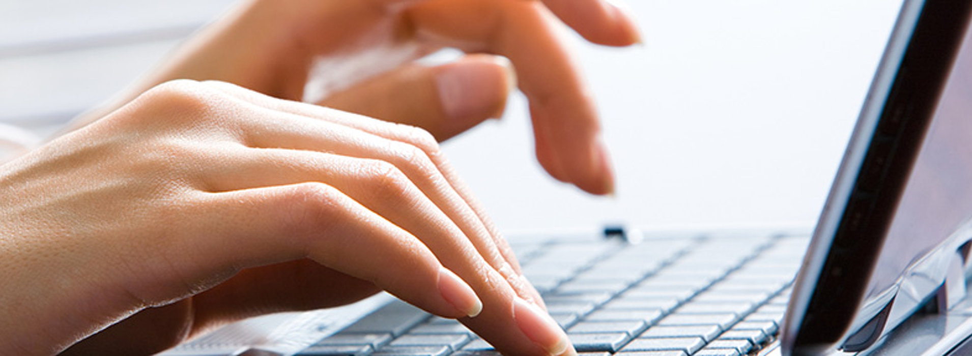 Close-up of Hands typing on a Laptop Keyboard